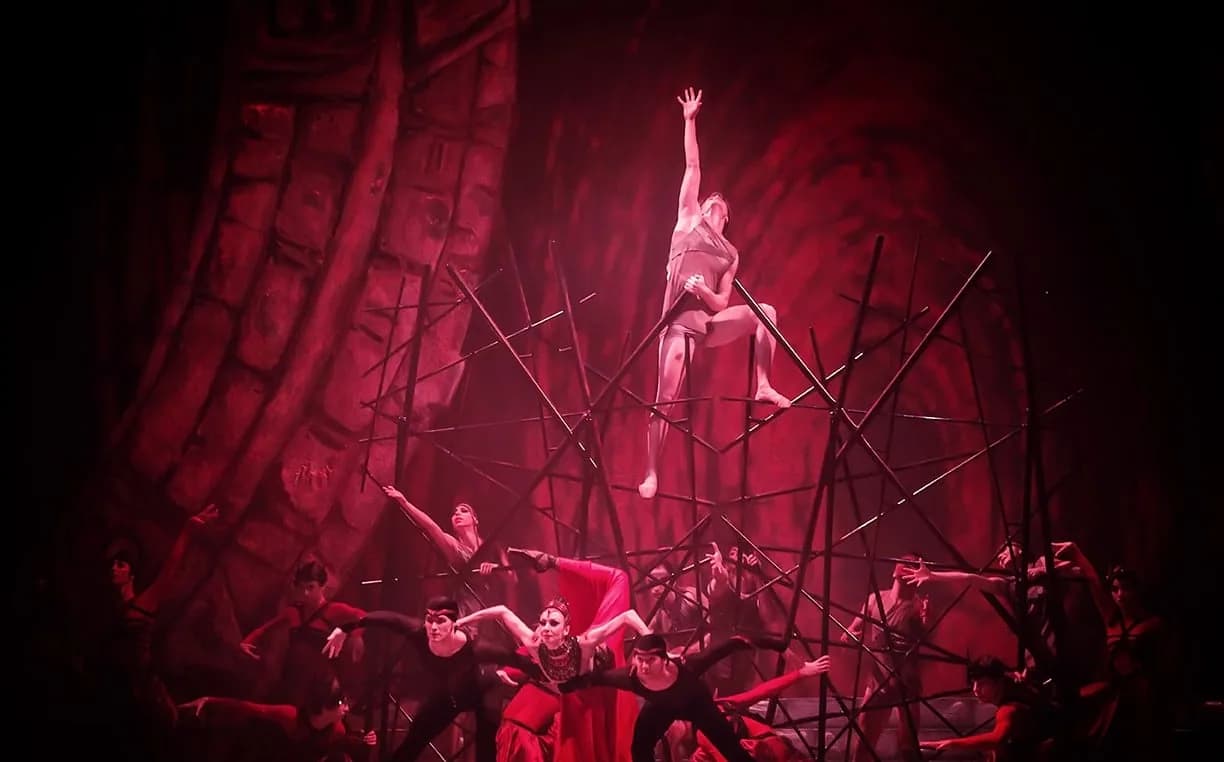 Ensemble de danseurs sous une lumière rouge intense