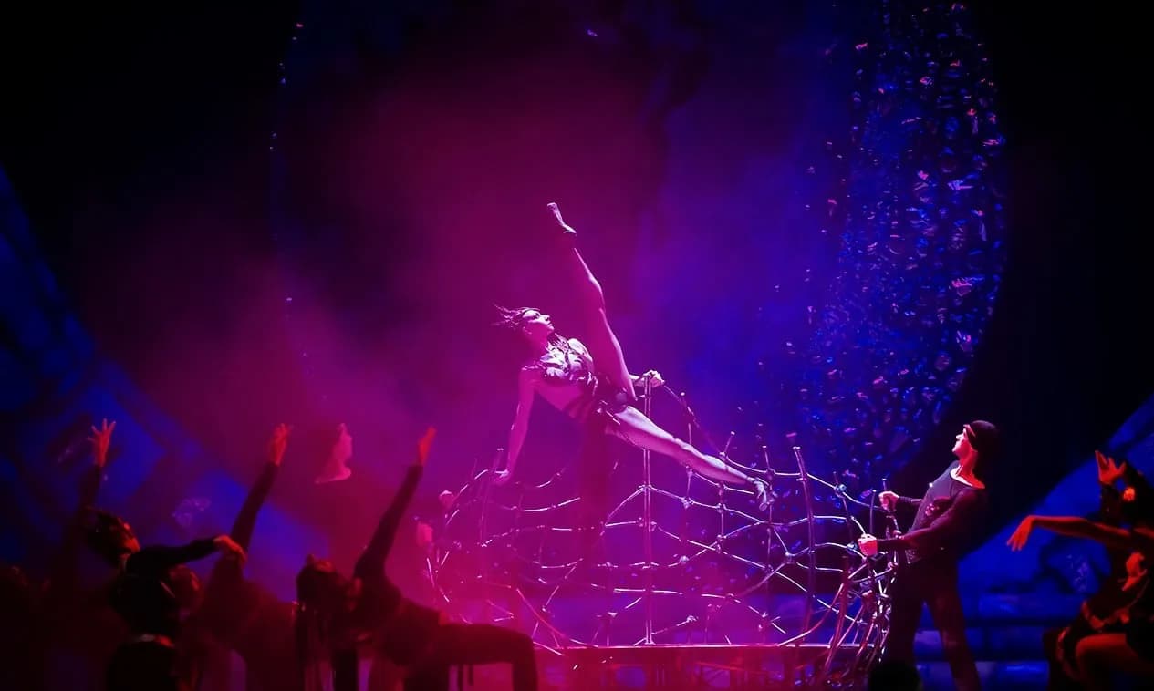 Danseuse projetée en l'air au-dessus d'une structure métallique