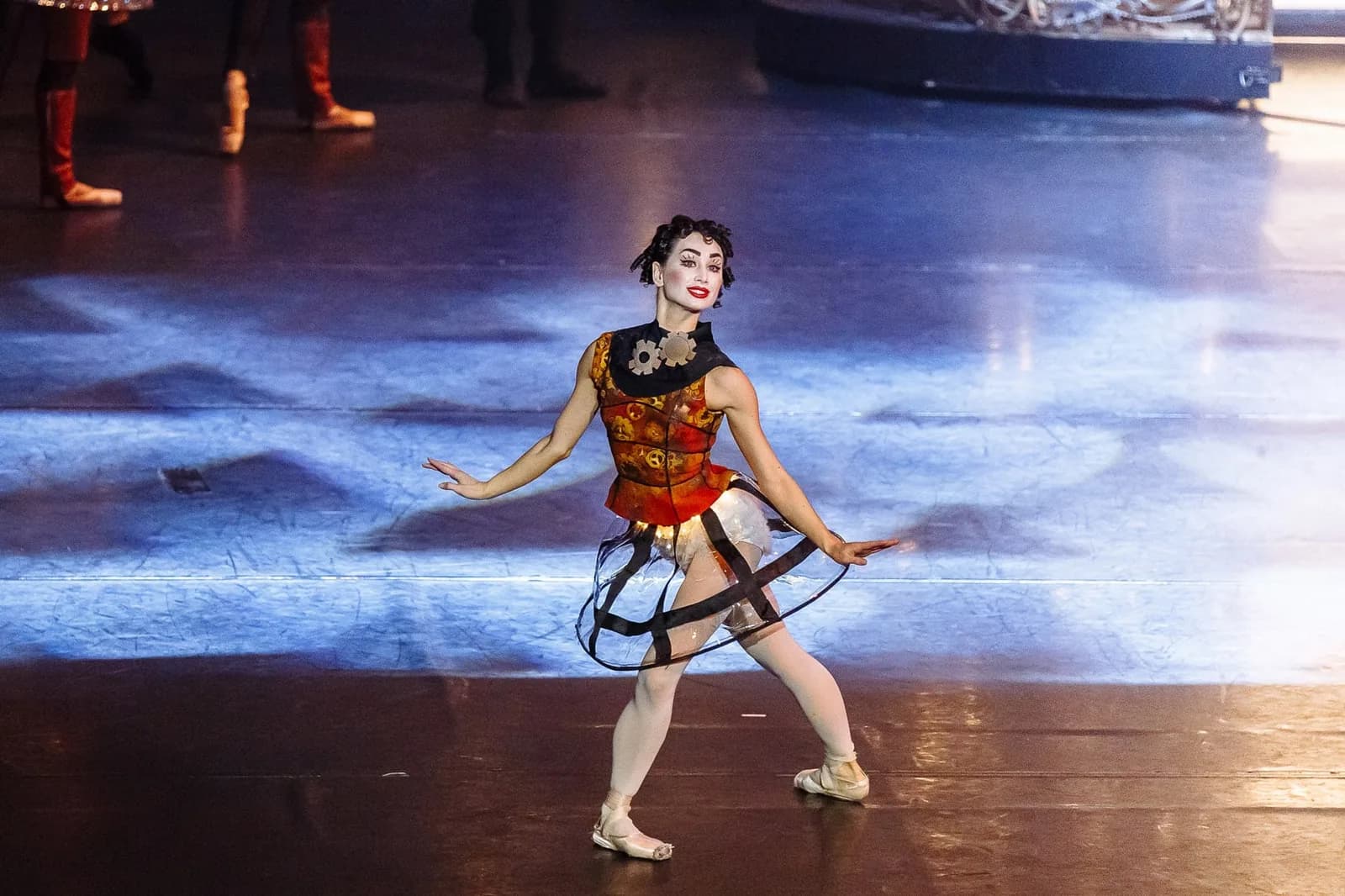 Danseuse en costume d'automate et jupe à cerceaux, en fente sur le plateau